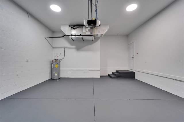 6097 Vermont Ave, New Port Richey, FL 34653 - garage featuring water heater, recessed lighting, and a garage door opener