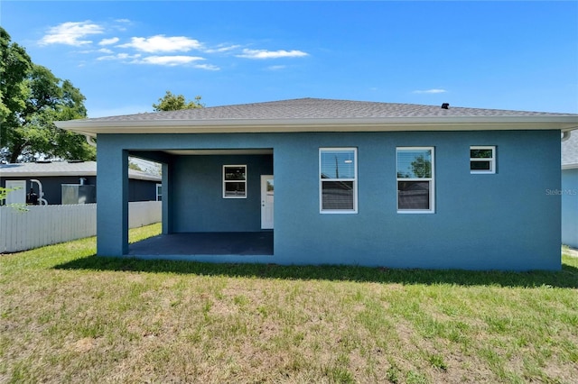6097 Vermont Ave, New Port Richey, FL 34653 - back of property featuring a patio area, stucco siding, and a shingled roof