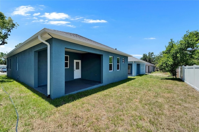 6097 Vermont Ave, New Port Richey, FL 34653 - rear view of house with a patio and stucco siding
