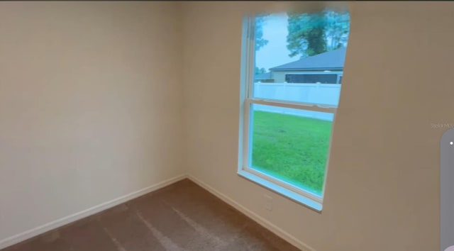 5407 Kedgewick Ln, North Port, FL 34288 - unfurnished room with baseboards and dark colored carpet