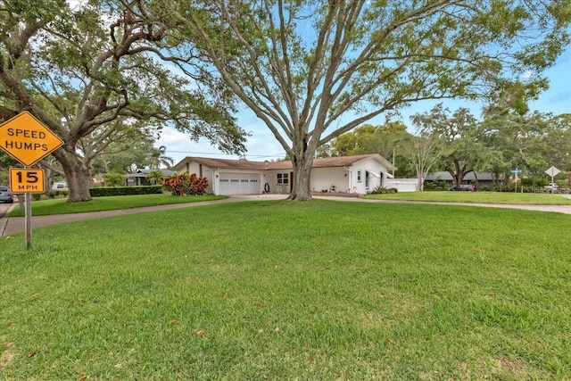 1666 Souvenir Dr, Clearwater, FL 33755 - view of front facade featuring a garage, a front yard, and driveway
