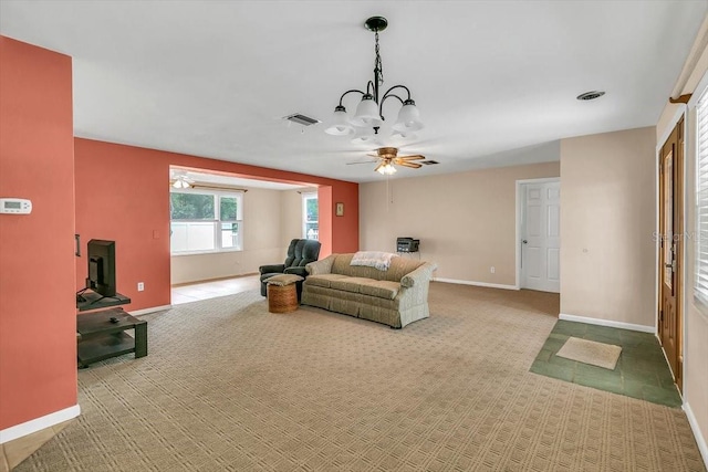 1666 Souvenir Dr, Clearwater, FL 33755 - carpeted living room with ceiling fan, baseboards, and a chandelier