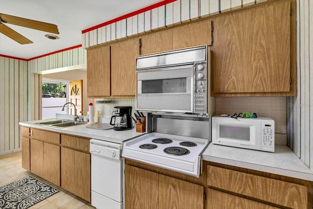 1666 Souvenir Dr, Clearwater, FL 33755 - kitchen with white appliances, a sink, ceiling fan, light countertops, and light tile patterned flooring