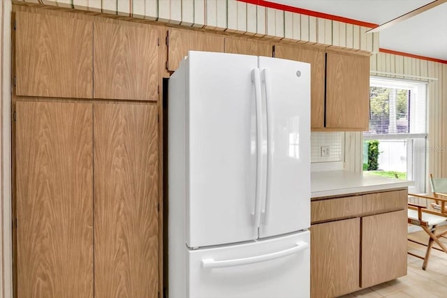 1666 Souvenir Dr, Clearwater, FL 33755 - kitchen with freestanding refrigerator, light countertops, and backsplash