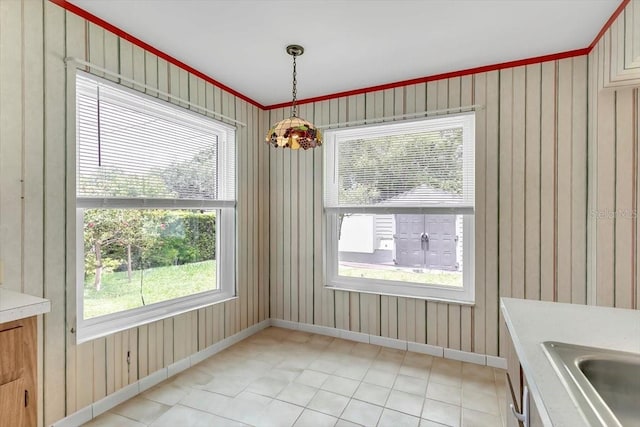 1666 Souvenir Dr, Clearwater, FL 33755 - unfurnished dining area featuring a sink, healthy amount of natural light, baseboards, and light tile patterned floors