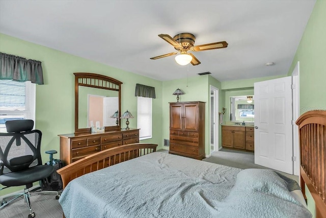 1666 Souvenir Dr, Clearwater, FL 33755 - bedroom with light carpet, connected bathroom, ceiling fan, and baseboards
