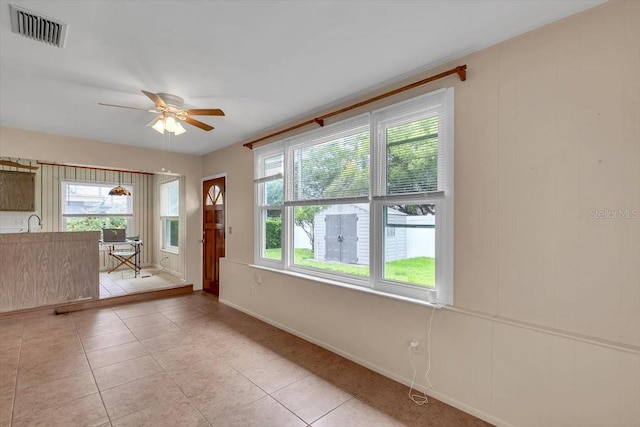 1666 Souvenir Dr, Clearwater, FL 33755 - empty room featuring a ceiling fan, light tile patterned flooring, and baseboards