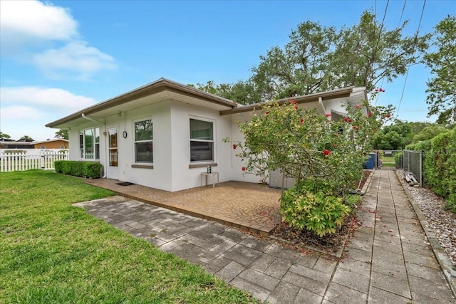 1666 Souvenir Dr, Clearwater, FL 33755 - rear view of property with a patio area and stucco siding