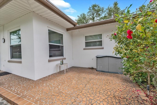 1666 Souvenir Dr, Clearwater, FL 33755 - view of property exterior featuring a patio area and stucco siding
