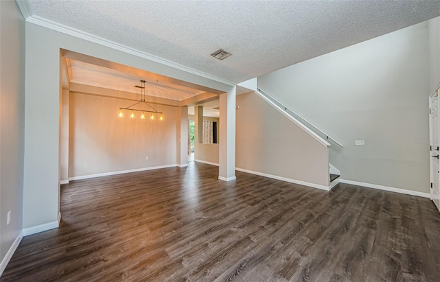 1712 Crossvine Ct, Trinity, FL 34655 - unfurnished living room featuring a chandelier, a textured ceiling, dark wood-type flooring, ornamental molding, and stairway