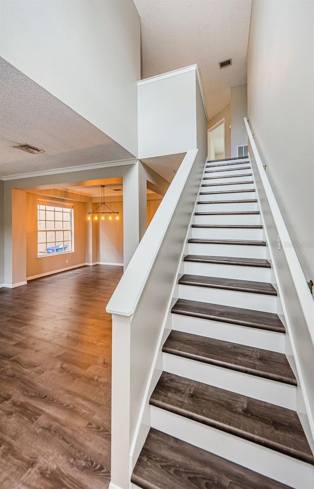 1712 Crossvine Ct, Trinity, FL 34655 - stairway with a textured ceiling, a chandelier, and wood finished floors