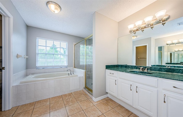 1712 Crossvine Ct, Trinity, FL 34655 - bathroom featuring a garden tub, vanity, a shower stall, tile patterned flooring, and a textured ceiling