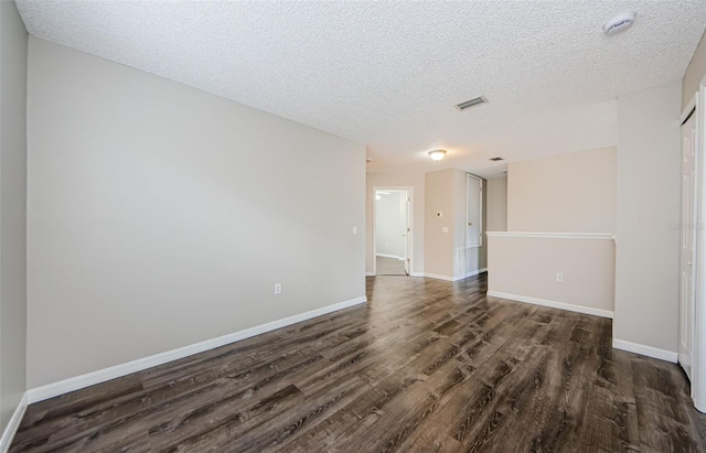 1712 Crossvine Ct, Trinity, FL 34655 - empty room featuring dark wood-style flooring, a textured ceiling, and a smoke detector