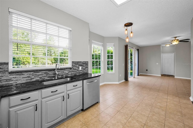 1712 Crossvine Ct, Trinity, FL 34655 - kitchen featuring dishwasher, decorative backsplash, light tile patterned floors, ceiling fan, and open floor plan