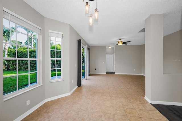 1712 Crossvine Ct, Trinity, FL 34655 - unfurnished room with ceiling fan, light tile patterned flooring, and a textured ceiling