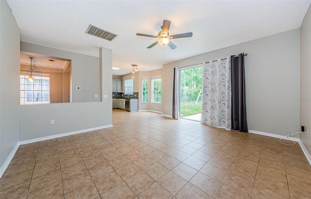 1712 Crossvine Ct, Trinity, FL 34655 - unfurnished living room with ceiling fan and light tile patterned flooring