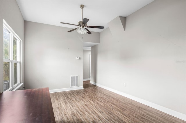unfurnished room featuring baseboards, wood finished floors, and ceiling fan