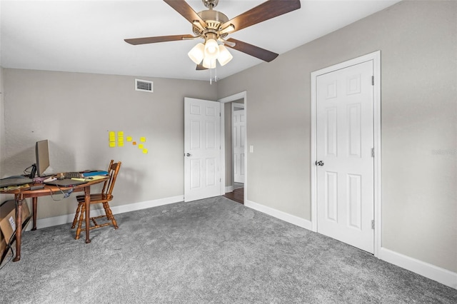 carpeted office featuring a ceiling fan and baseboards