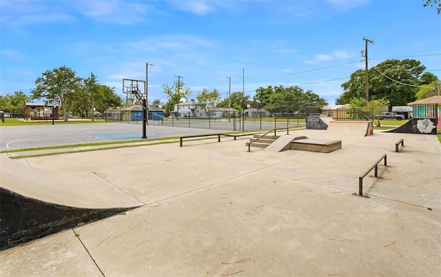view of basketball court featuring community basketball court and fence
