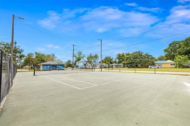 view of tennis court with fence