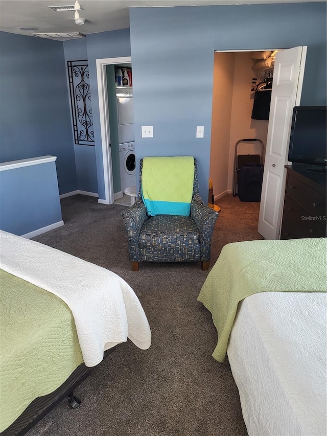 17960 Gulf Blvd Unit 101, Redington Shores, FL 33708 - carpeted bedroom featuring stacked washer / dryer, baseboards, a spacious closet, and a closet