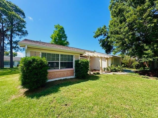 rear view of property with a yard