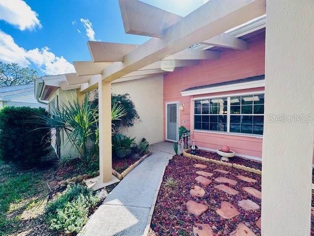 property entrance with stucco siding
