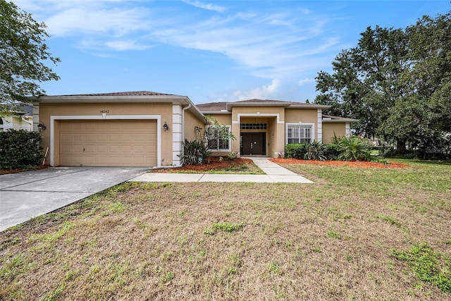 14042 Marlberry Way, Odessa, FL 33556 - view of front of house with stucco siding, an attached garage, concrete driveway, and a front lawn