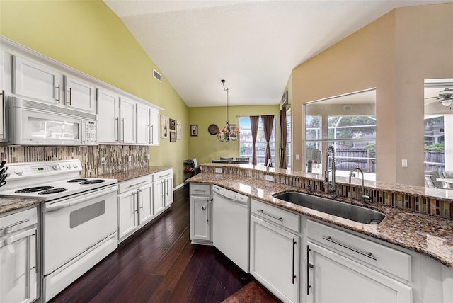 14042 Marlberry Way, Odessa, FL 33556 - kitchen featuring white appliances, a sink, vaulted ceiling, dark wood finished floors, and decorative backsplash