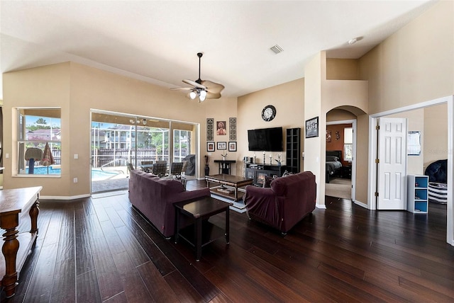 14042 Marlberry Way, Odessa, FL 33556 - living area with arched walkways, a ceiling fan, dark wood-style floors, baseboards, and a towering ceiling