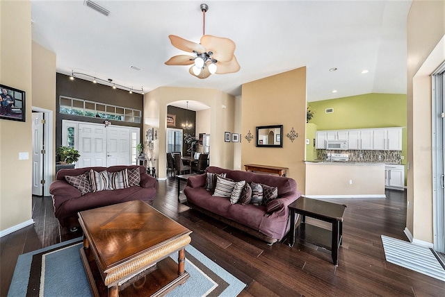 14042 Marlberry Way, Odessa, FL 33556 - living area with arched walkways, dark wood finished floors, ceiling fan, track lighting, and vaulted ceiling