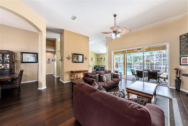 14042 Marlberry Way, Odessa, FL 33556 - living area featuring arched walkways, dark wood-type flooring, a ceiling fan, and baseboards