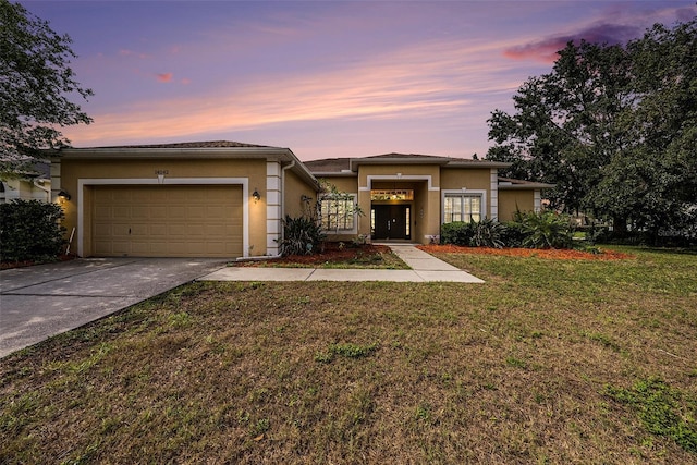 14042 Marlberry Way, Odessa, FL 33556 - view of front of property featuring a garage, stucco siding, concrete driveway, and a yard