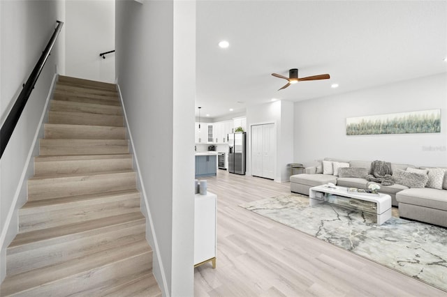 stairs featuring recessed lighting, ceiling fan, and wood finished floors
