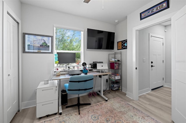 office space with wood finished floors, ceiling fan, and baseboards