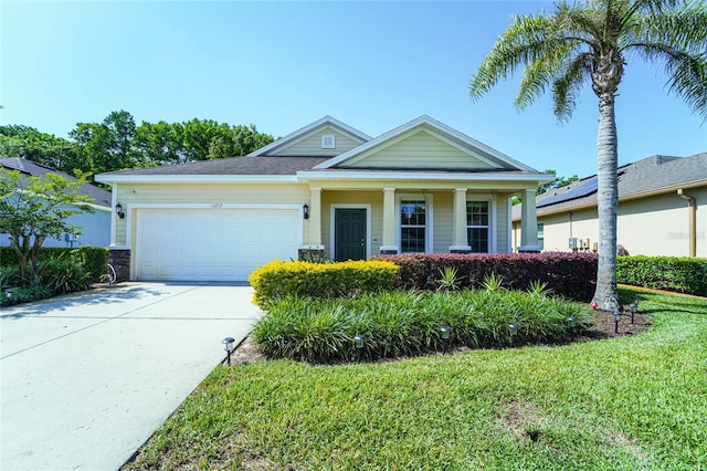 view of front facade with an attached garage, concrete driveway, a front lawn, a porch, and central AC