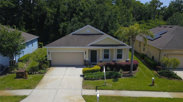 view of front of property featuring a garage, driveway, a front yard, and a shingled roof