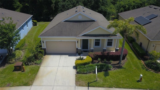 view of front of property featuring an attached garage, driveway, roof with shingles, and a front yard