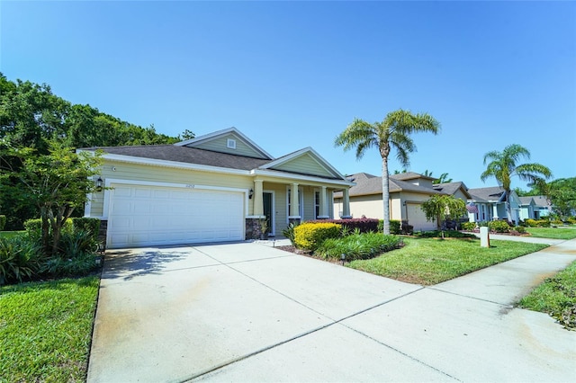 view of front of home with a garage, a front yard, and concrete driveway