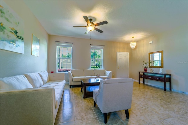 living room with ceiling fan and a chandelier
