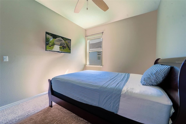 carpeted bedroom featuring baseboards and a ceiling fan