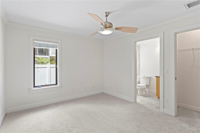 512 S Glen Ave, Tampa, FL 33609 - unfurnished bedroom with ornamental molding, light colored carpet, a walk in closet, a closet, and baseboards