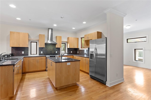 512 S Glen Ave, Tampa, FL 33609 - kitchen featuring appliances with stainless steel finishes, wall chimney range hood, a sink, dark stone counters, and ornamental molding