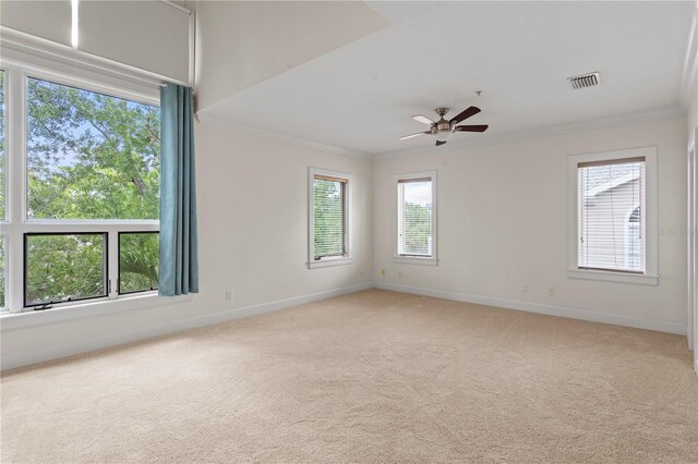 512 S Glen Ave, Tampa, FL 33609 - unfurnished room with crown molding, light carpet, baseboards, and a ceiling fan