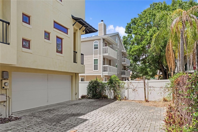 512 S Glen Ave, Tampa, FL 33609 - view of patio / terrace featuring fence, decorative driveway, and a garage