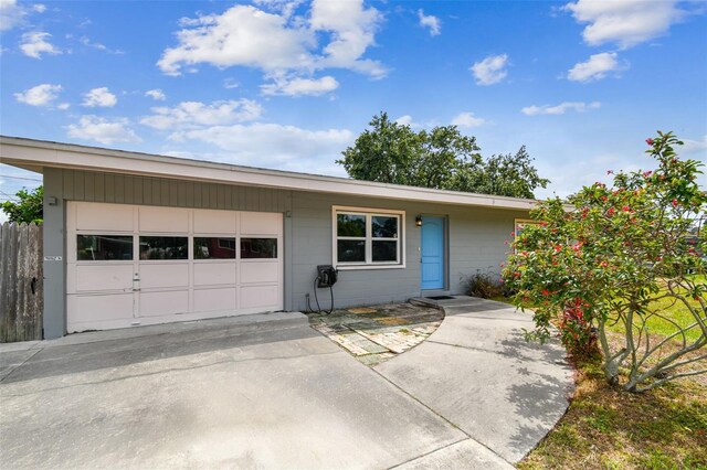 8528 Iris Ave, Seminole, FL 33777 - view of front facade featuring an attached garage, concrete driveway, and concrete block siding