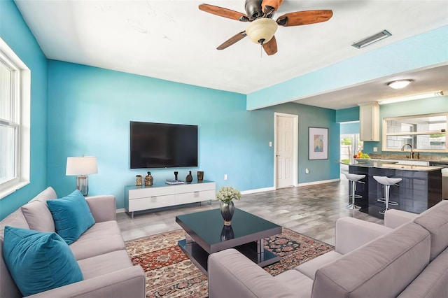 8528 Iris Ave, Seminole, FL 33777 - living room featuring light wood finished floors, baseboards, and ceiling fan