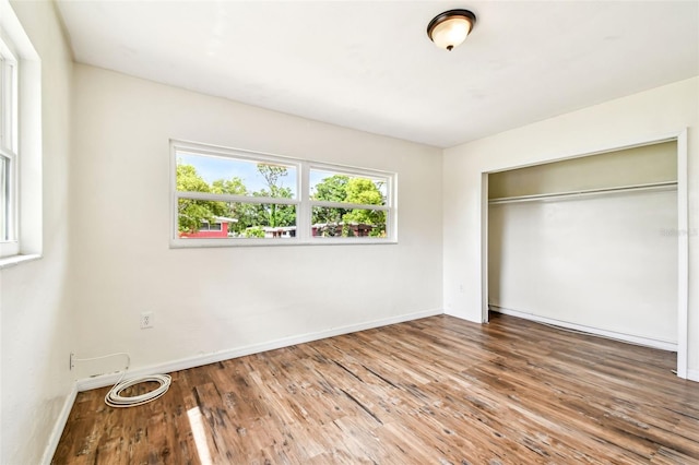 8528 Iris Ave, Seminole, FL 33777 - unfurnished bedroom featuring wood finished floors, baseboards, and a closet