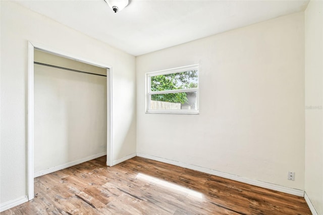 8528 Iris Ave, Seminole, FL 33777 - unfurnished bedroom with wood finished floors, baseboards, and a closet