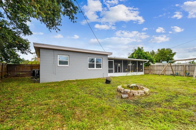 8528 Iris Ave, Seminole, FL 33777 - back of property featuring a sunroom, an outdoor fire pit, and cooling unit